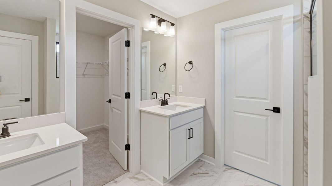 Bathroom with dual vanity and access to primary closet Bathroom with dual vanity and access to primary closet