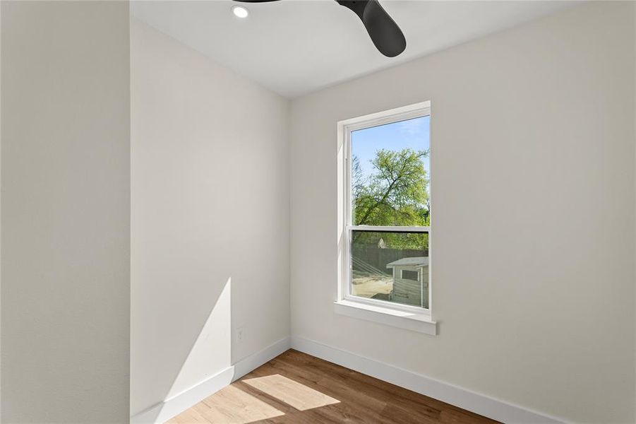 Empty room with ceiling fan, light wood-style floors, and recessed lighting
