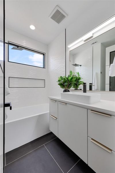 Full bath featuring vanity, dark tile patterned floors, shower / bathtub combination, and recessed lighting