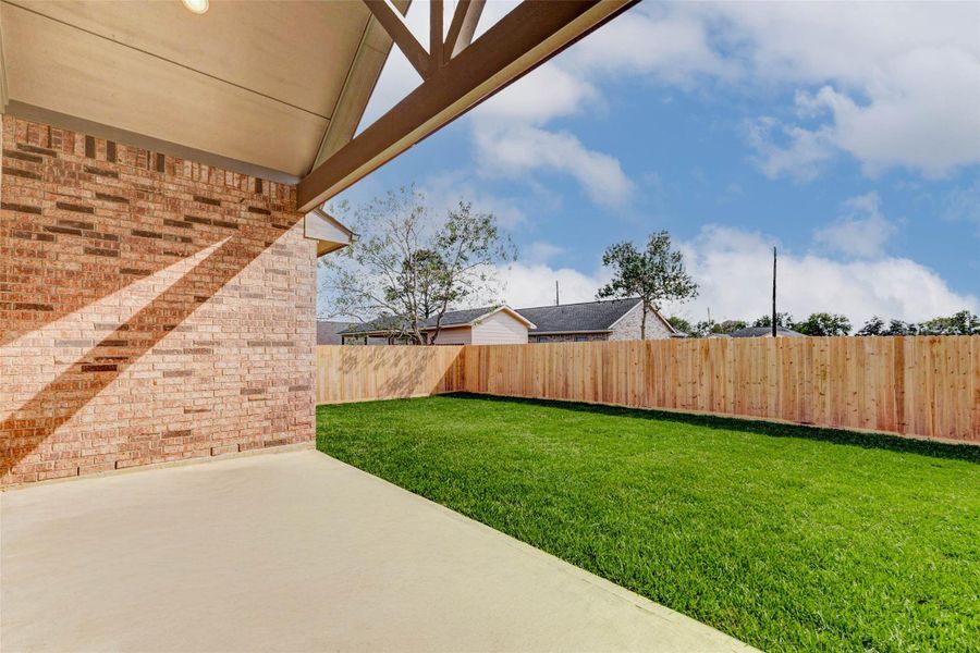 Enjoy a covered back patio with high ceiling and fan pre-wire, perfect for entertaining. Enjoy a covered back patio with high ceiling and fan pre-wire, perfect for entertaining.