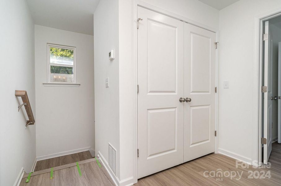 Representative Photo. Landing area upstairs with laundry