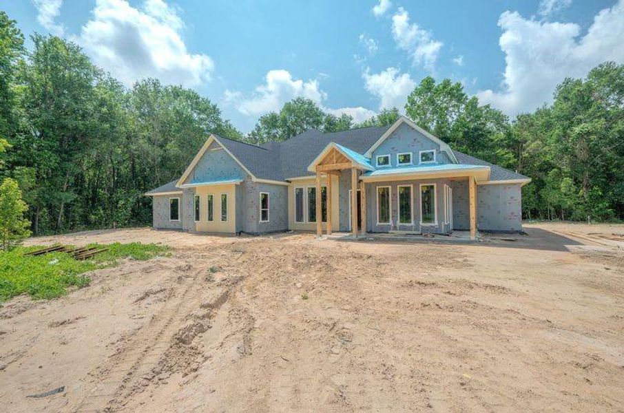Front exterior of a new home in Silver Creek Ranch, Montgomery, TX, highlighting curb appeal (Image 2). Front exterior of a new home in Silver Creek Ranch, Montgomery, TX, highlighting curb appeal (Image 2).