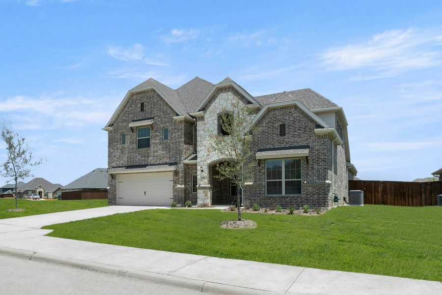 Front exterior of a new home in Westside Preserve, Midlothian, TX, highlighting curb appeal (Image 2).
