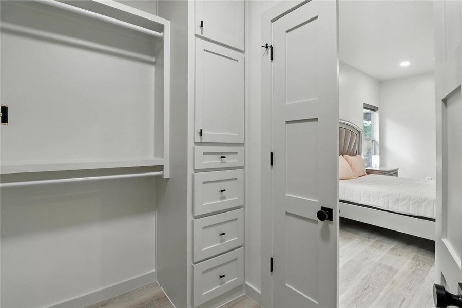 Spacious closet with light wood-style flooring