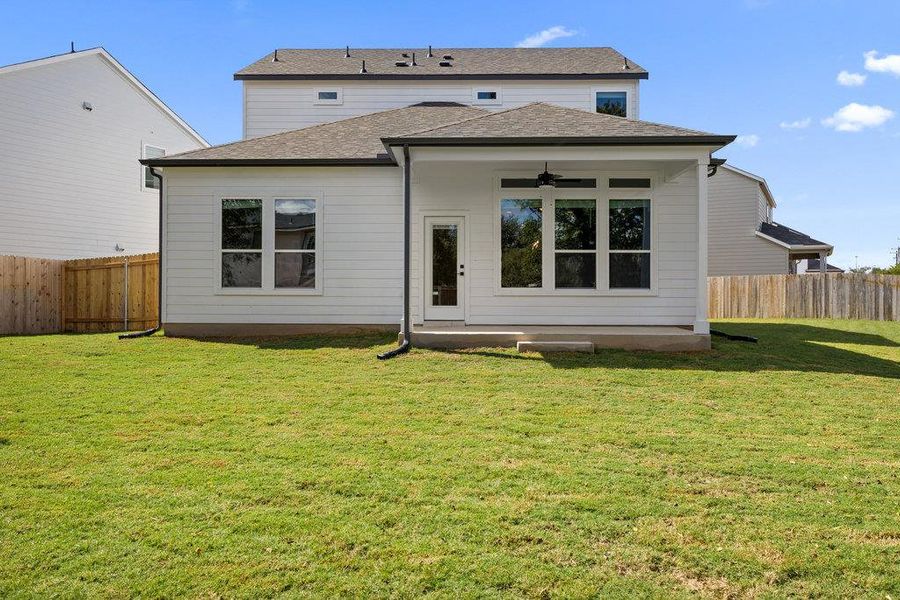 Back of property featuring ceiling fan, a fenced backyard, a patio, and roof with shingles