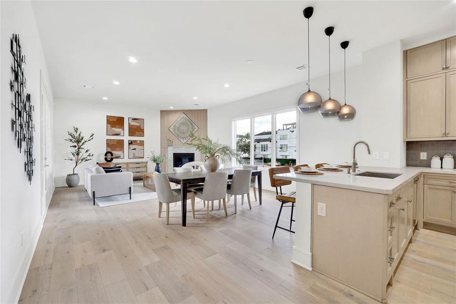 Open concept kitchen and living area with natural lights form multiple directions.