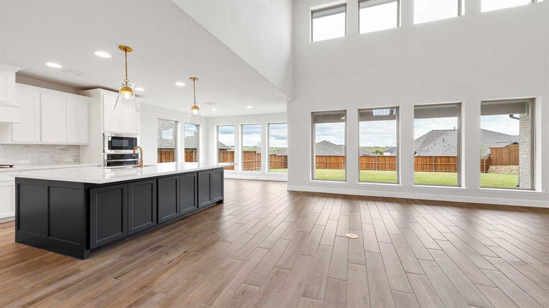 Kitchen featuring an island with sink, stainless steel appliances, and plenty of natural light