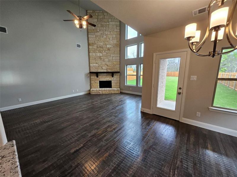 Stone fireplace to the ceiling with cedar mantle and gas starter