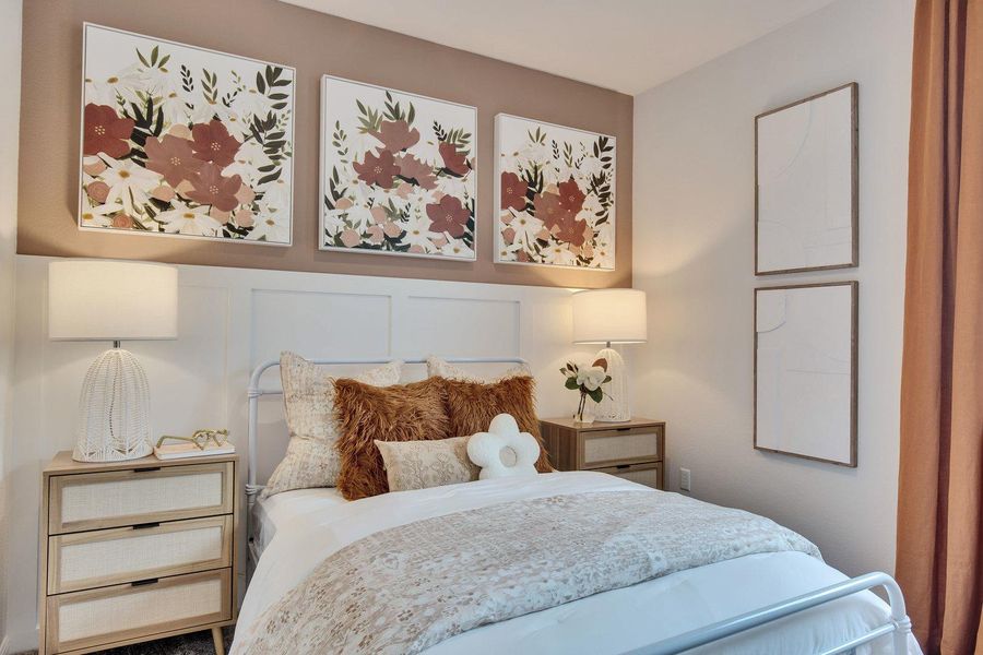 A well-lit primary bedroom features a striking accent wall, showcasing a tasteful bed frame and convenient nightstands. A well-lit primary bedroom features a striking accent wall, showcasing a tasteful bed frame and convenient nightstands.