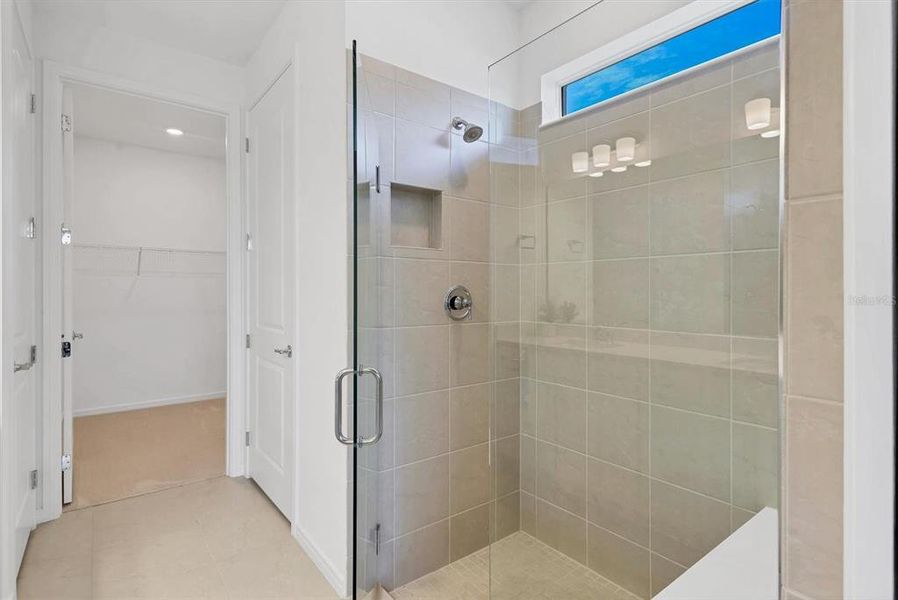 Walk-in shower with bench and frameless glass surround