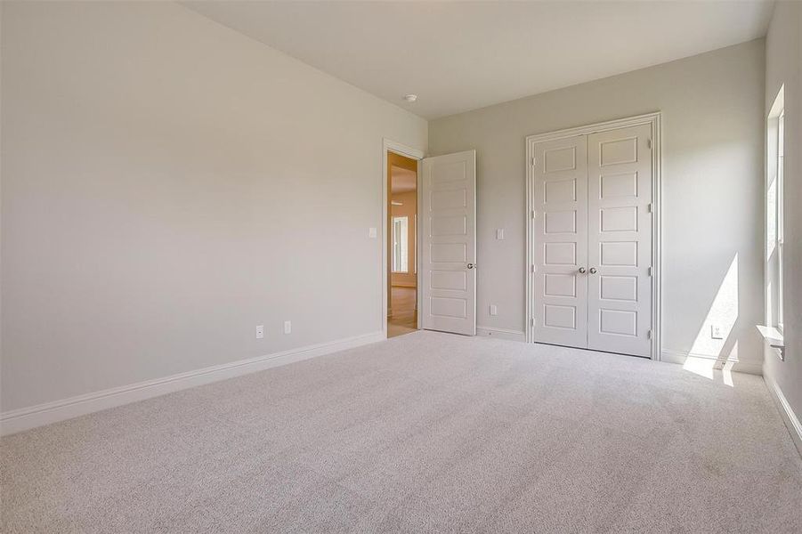 Unfurnished bedroom with carpet and a closet