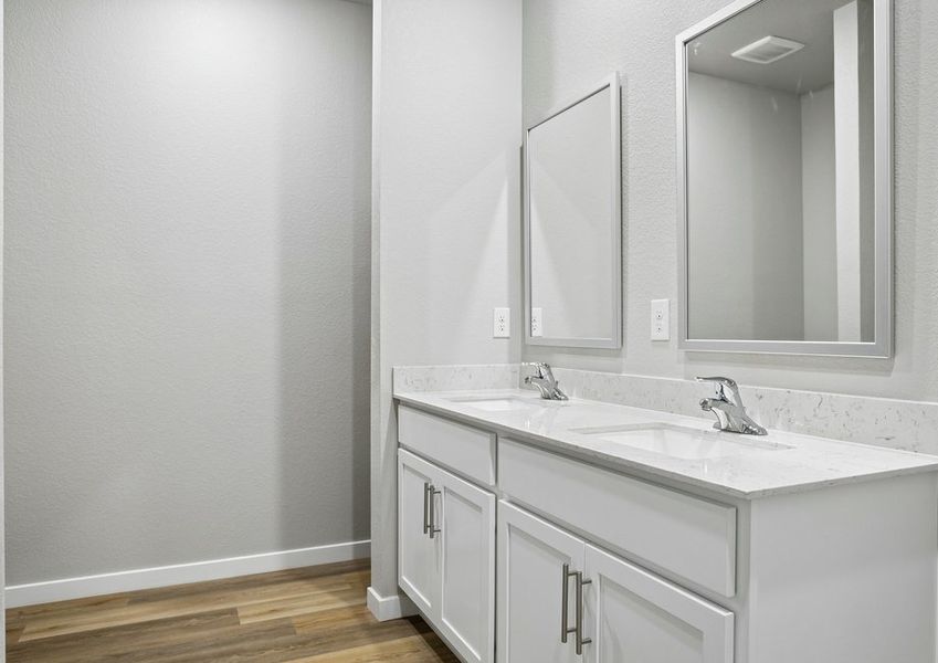The master bathroom has a large vanity and step in shower.