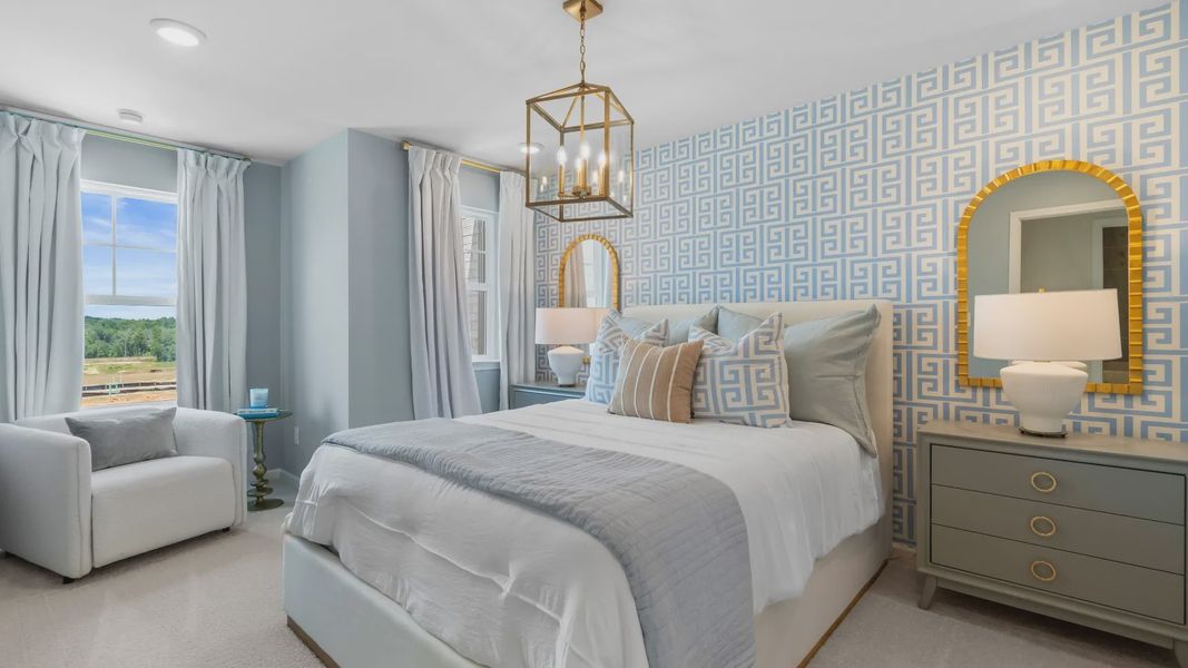Elegant bedroom in new construction townhome with a comfortable layout and large windows.