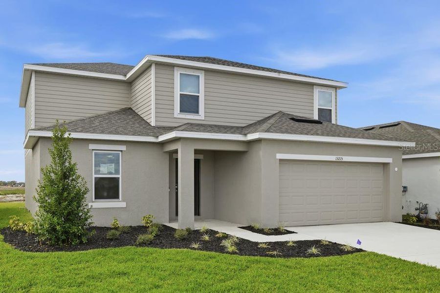 Front exterior of a new home in Firethorn, Parrish, FL, highlighting curb appeal (Image 2). Front exterior of a new home in Firethorn, Parrish, FL, highlighting curb appeal (Image 2).