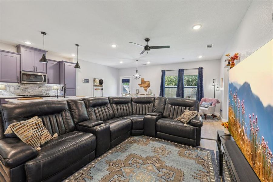 Living room featuring recessed lighting, ceiling fan, and wood finished floors Living room featuring recessed lighting, ceiling fan, and wood finished floors