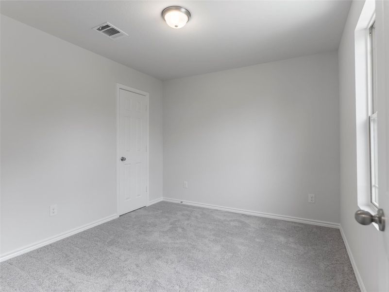 Cozy upstairs bedroom with plush carpeting.