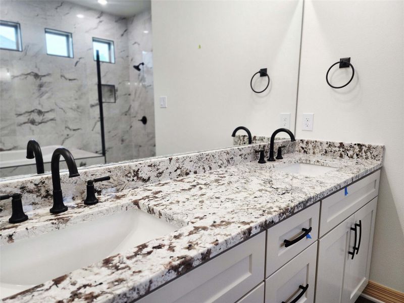 Double vanity featuring integrated sinks and patterned countertops