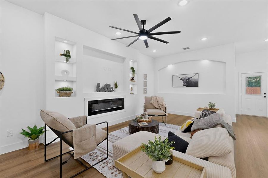 Living area featuring wood-finish flooring, recessed lighting, and a contemporary ceiling fan