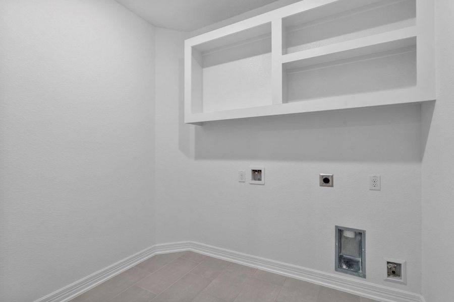 The laundry room layout is carefully planned for optimal workflow with designated areas for washing, drying, and storing.