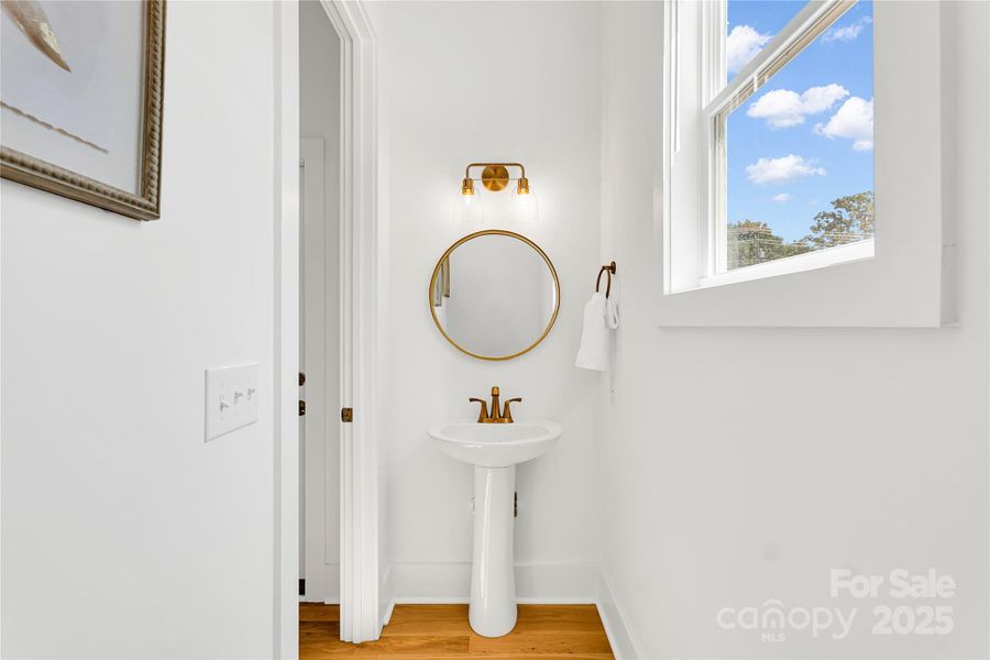 Half bath off of hall from laundry room