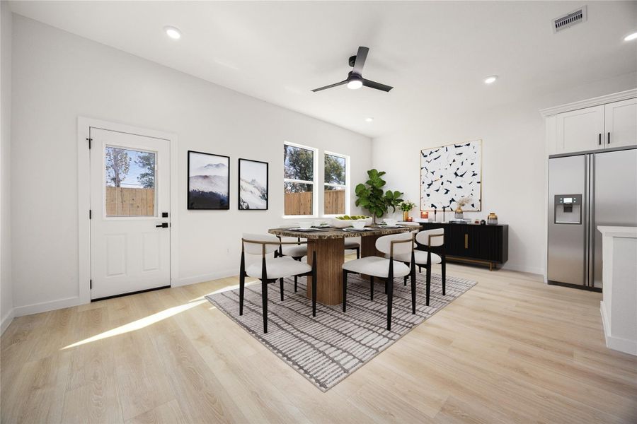 Light-filled dining area with large windows, modern ceiling fan, and ample space for entertaining, perfectly positioned adjacent to the kitchen for everyday living and gatherings. *Virtually Staged Light-filled dining area with large windows, modern ceiling fan, and ample space for entertaining, perfectly positioned adjacent to the kitchen for everyday living and gatherings. *Virtually Staged
