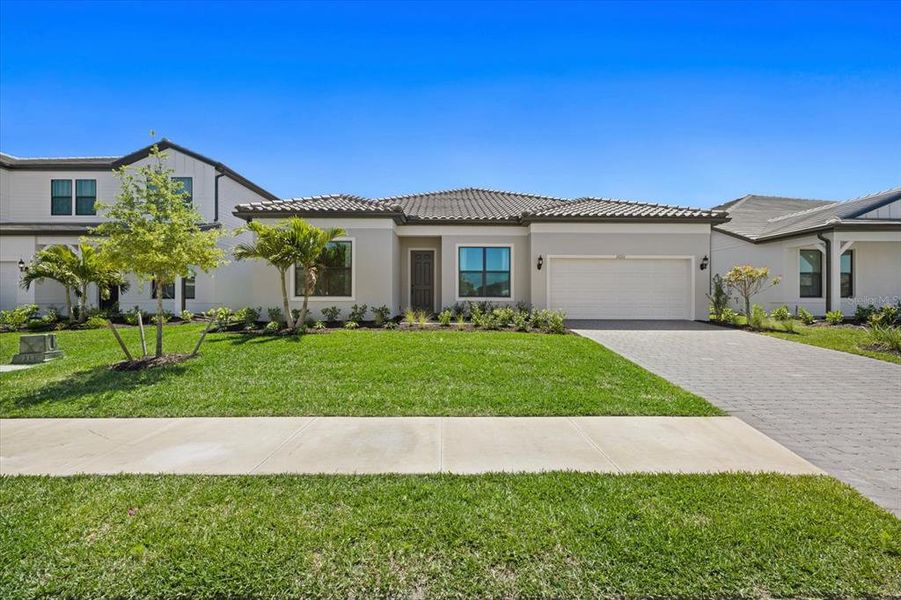 Front exterior of a new home in , Lakewood Ranch, FL, highlighting curb appeal (Image 21). Front exterior of a new home in , Lakewood Ranch, FL, highlighting curb appeal (Image 21).