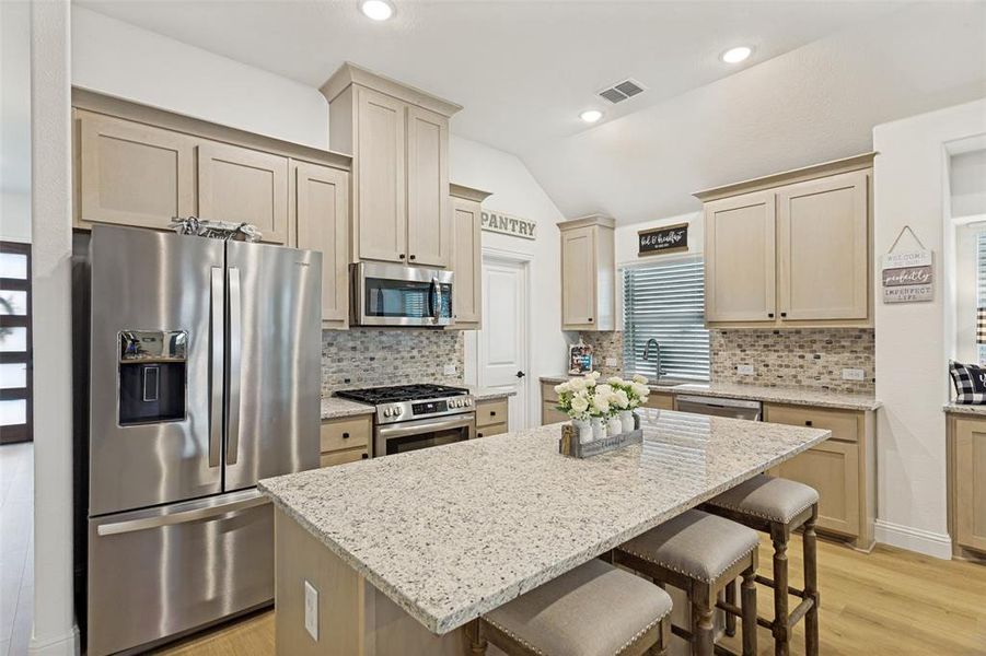Kitchen features an island with room for barstools