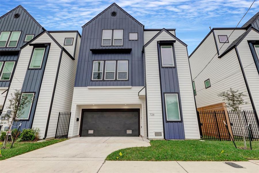 A view of your new home from the street. The driveway provides additional parking and you can see the access to your side yard space.