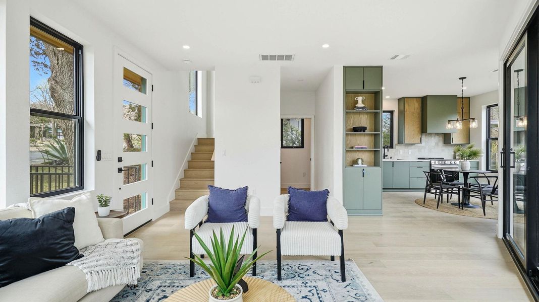 Living area featuring light wood-style floors and recessed lighting