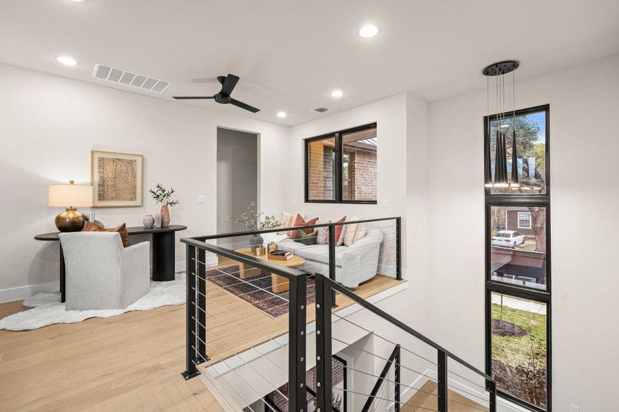 Corridor with recessed lighting, an upstairs landing, and light wood-style floors