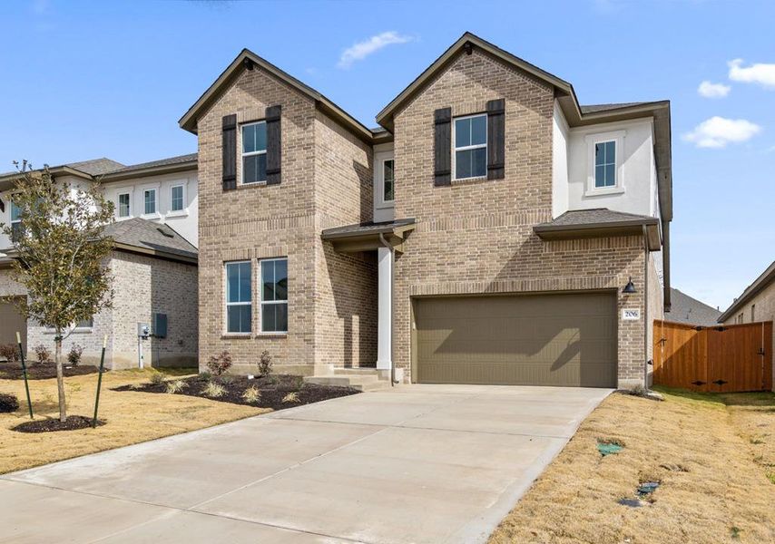 Front exterior of a new home in Arbor Collection at Lariat, Liberty Hill, TX, highlighting curb appeal (Image 1).