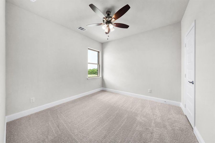 Unfurnished bedroom featuring carpet floors and ceiling fan Unfurnished bedroom featuring carpet floors and ceiling fan
