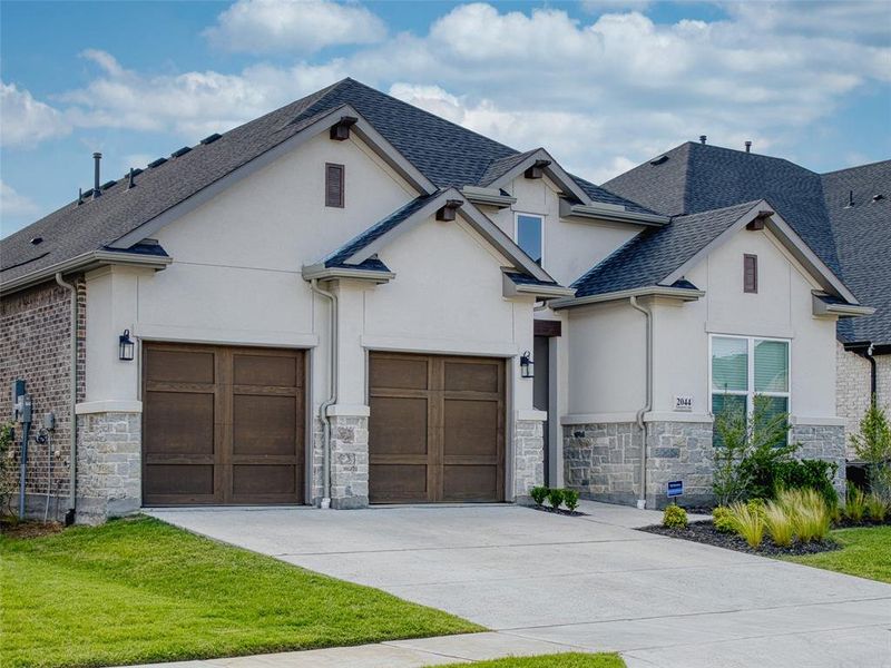 Front exterior of a new home in , Prosper, TX, highlighting curb appeal (Image 2). Front exterior of a new home in , Prosper, TX, highlighting curb appeal (Image 2).
