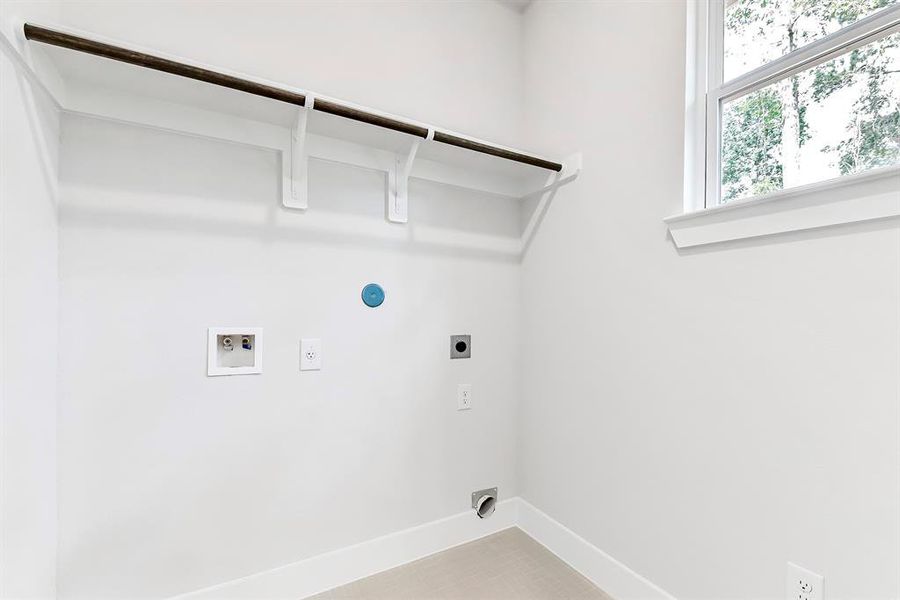 Laundry room with shelf.