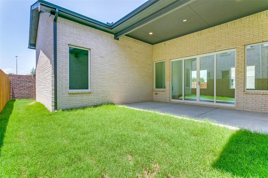 Back of property featuring brick siding and a patio Back of property featuring brick siding and a patio