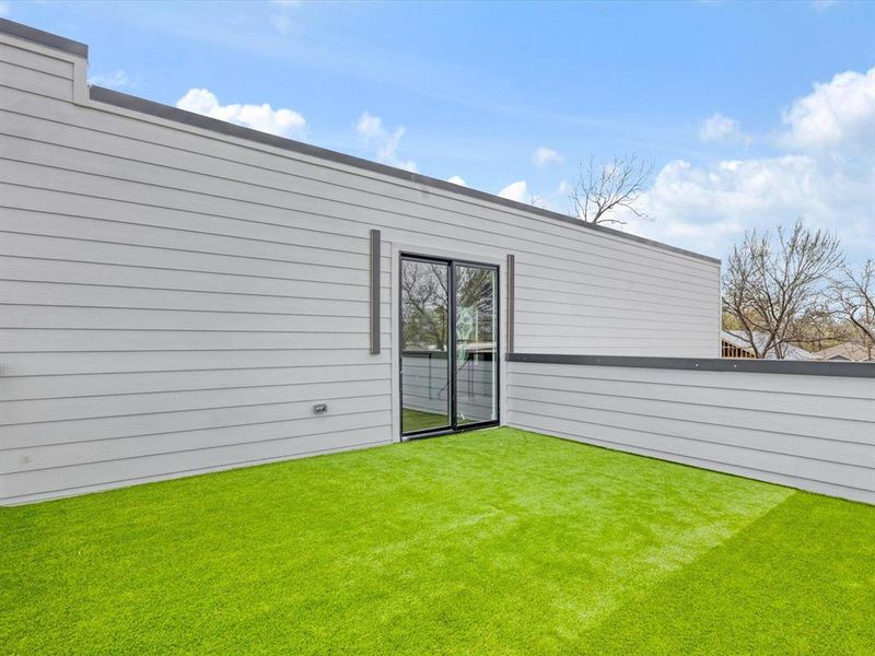Rooftop deck accessible through the sliding doors from the game room on the second floor.