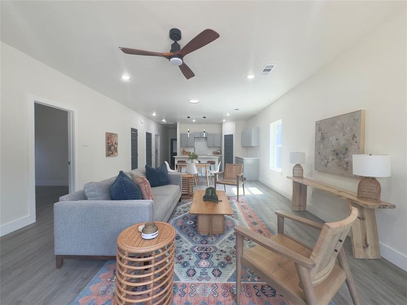 Living room featuring ceiling fan and hardwood / wood-style flooring