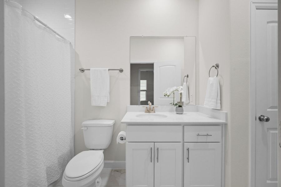 The second-floor hall bath with tub/shower combo, quartz counter, and undermount sink — the linen closet is also visible here, keeping everything your household needs within easy reach. The second-floor hall bath with tub/shower combo, quartz counter, and undermount sink — the linen closet is also visible here, keeping everything your household needs within easy reach.