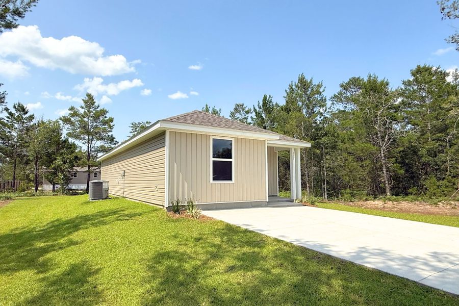 A small house with a driveway. A small house with a driveway.