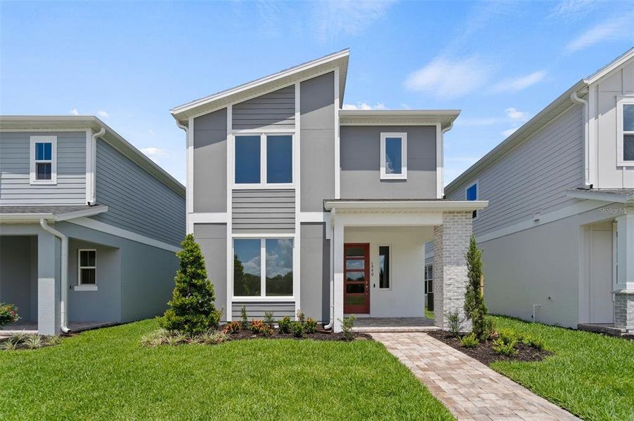 Front exterior of a new home in Trinity Place, St. Cloud, FL, highlighting curb appeal (Image 1).