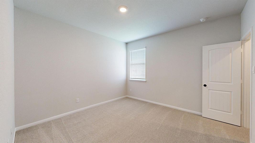Spare room featuring light colored carpet and baseboards Spare room featuring light colored carpet and baseboards