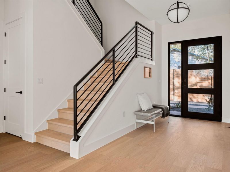 Foyer entrance featuring light wood-style flooring and stairs