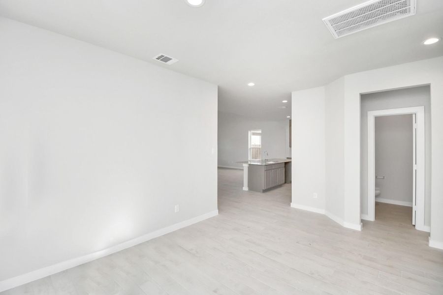 Make memories gathered around the table with your family and friends! This dining spacious room features elegant flooring, custom paint, and adjacent to family room and kitchen for open concept feel. Sample photo of completed home with similar floor plan. Actual colors and selections may vary.