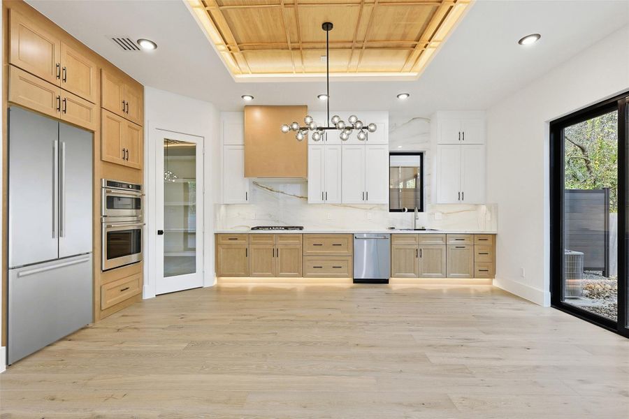 The kitchen features a custom wood-slat tray ceiling with integrated lighting and a modern globe chandelier.