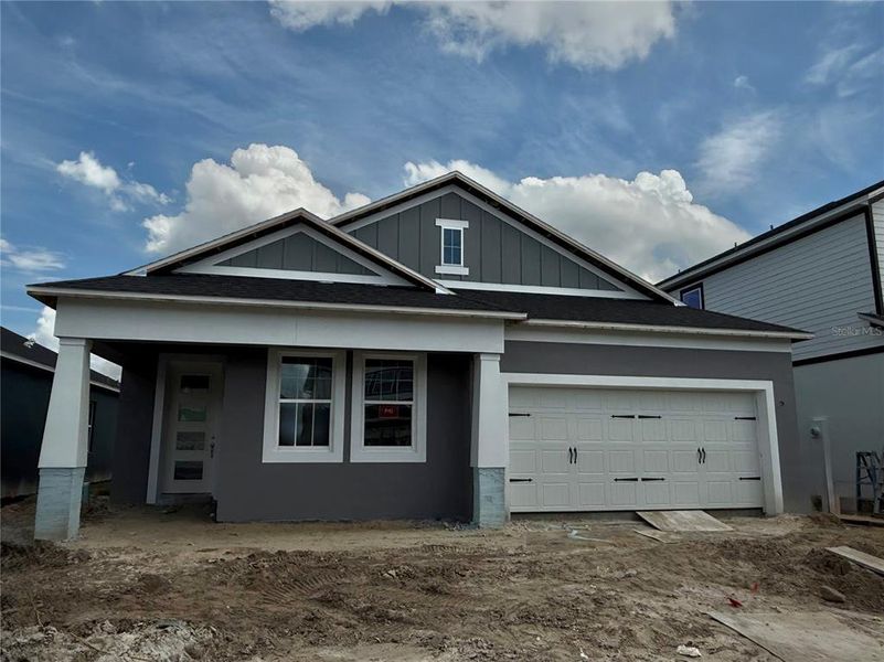 Front exterior of a new home in Estates at Rivercrest, Sanford, FL, highlighting curb appeal (Image 1).