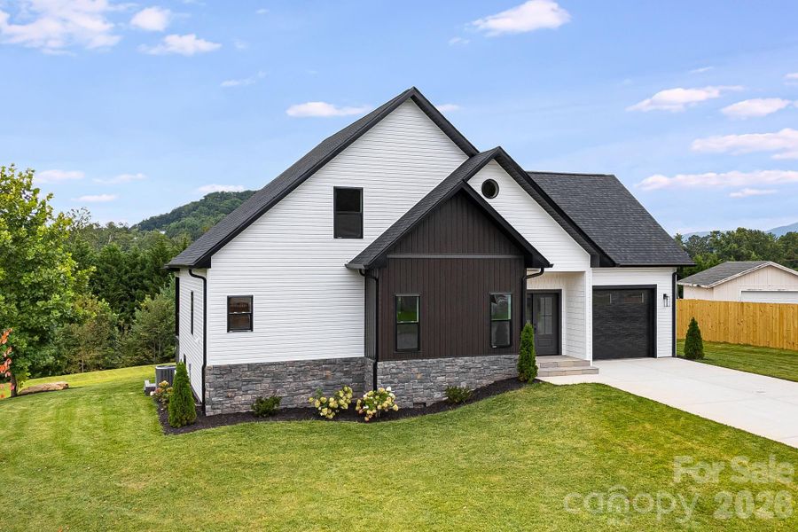 Front exterior of a new home in , Hendersonville, NC, highlighting curb appeal (Image 17).