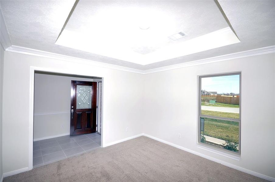 Dining off the Foyer includes a quality crafted tray ceiling.