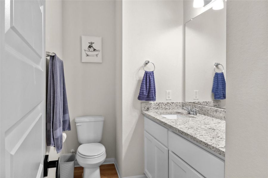 Bathroom featuring vanity and dark wood-style flooring
