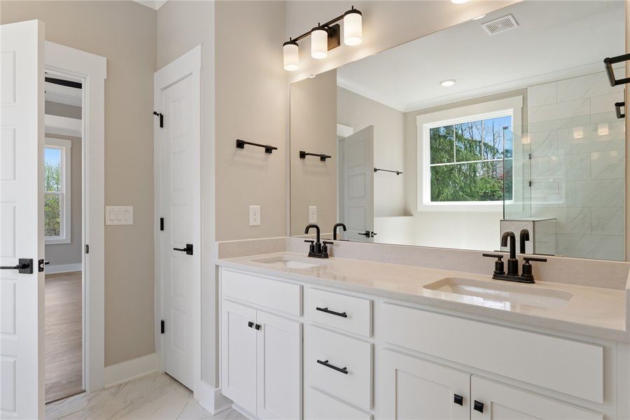 Dual vanities with quartz countertops and sleek bl Dual vanities with quartz countertops and sleek bl