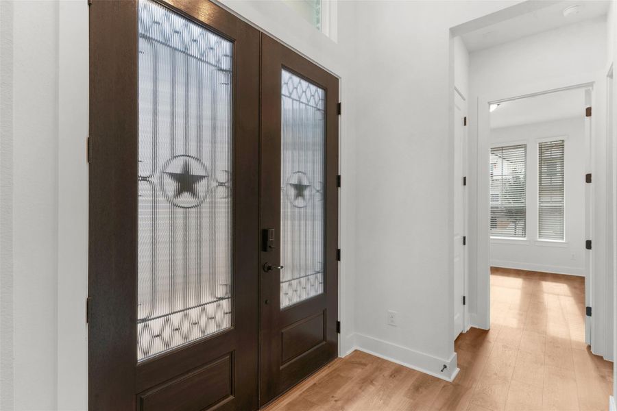 Entrance foyer with french doors and light wood finished floors